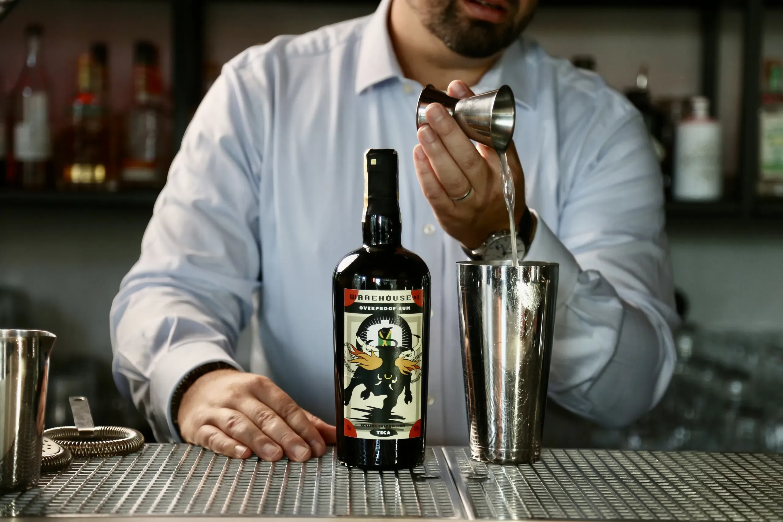 A bartender measuring Warehouse #1 overproof rum